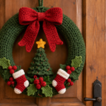 Handmade green Christmas wreath crochet pattern with a large red bow, mini tree, yellow star, stockings, holly leaves, and red berries.